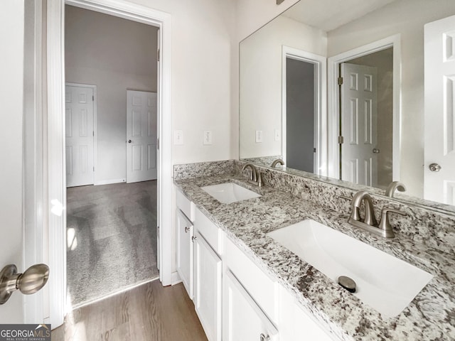 bathroom featuring vanity and hardwood / wood-style flooring