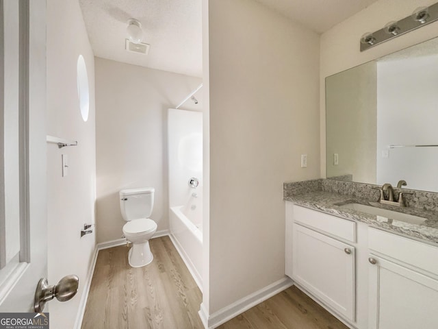 full bathroom featuring shower / bathing tub combination, vanity, wood-type flooring, and toilet