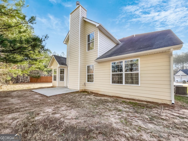 rear view of house featuring a patio and central AC