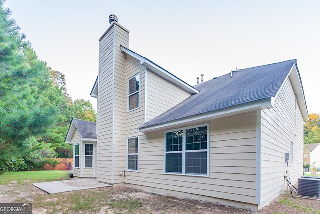 back of property with cooling unit and a patio