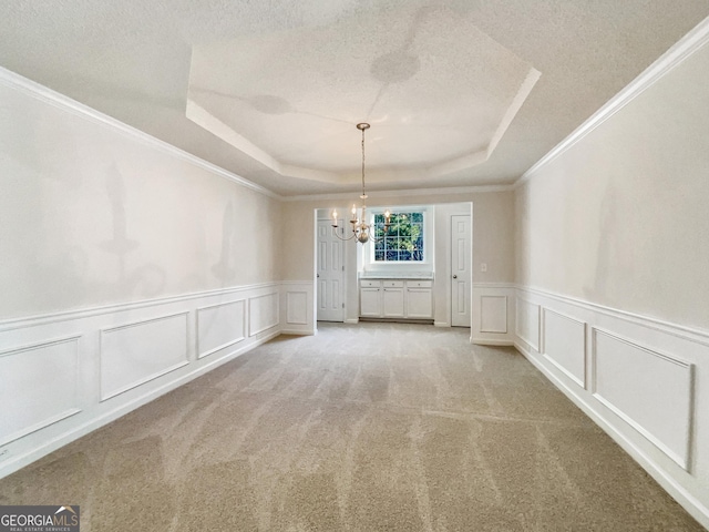 unfurnished dining area with a tray ceiling, carpet, and a notable chandelier