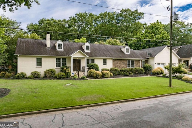 cape cod home with a front yard