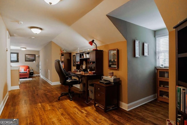 office space featuring vaulted ceiling and dark hardwood / wood-style flooring