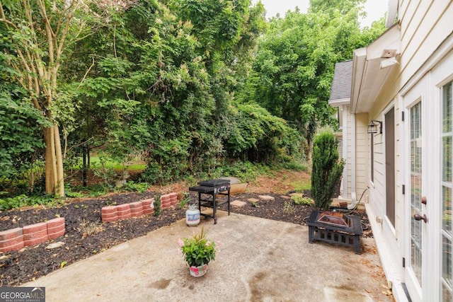 view of patio featuring an outdoor fire pit