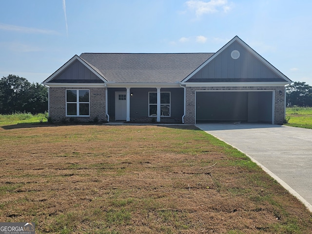 view of front of house featuring a front yard and a garage