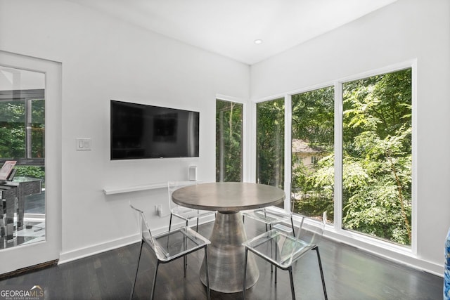 dining space with dark wood-type flooring