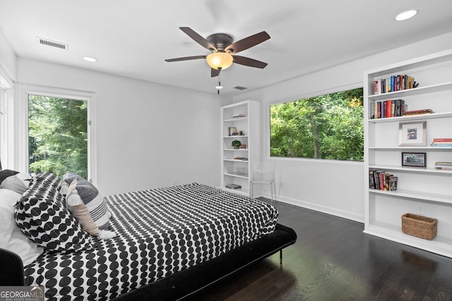 bedroom with ceiling fan and dark hardwood / wood-style flooring