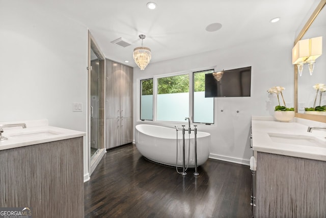 bathroom with shower with separate bathtub, dual bowl vanity, and hardwood / wood-style floors