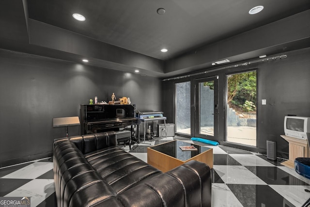 home theater featuring french doors and light tile floors