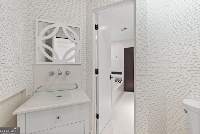 bathroom featuring tile floors, vanity, and toilet