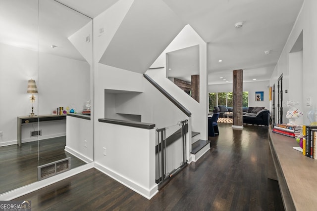 stairs with dark hardwood / wood-style flooring