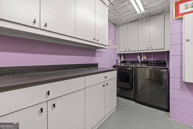 washroom with cabinets, washing machine and dryer, and hookup for an electric dryer