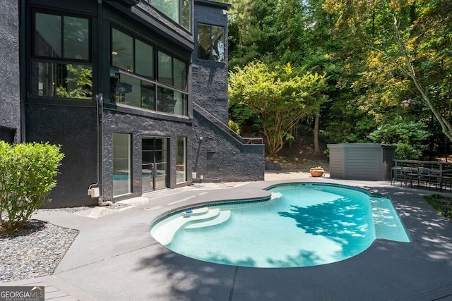 view of swimming pool with a patio