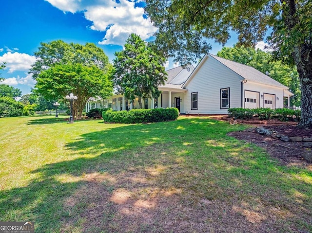 view of front of house with a front yard and a garage