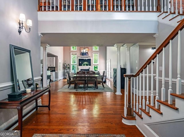 foyer with a high ceiling and hardwood / wood-style flooring