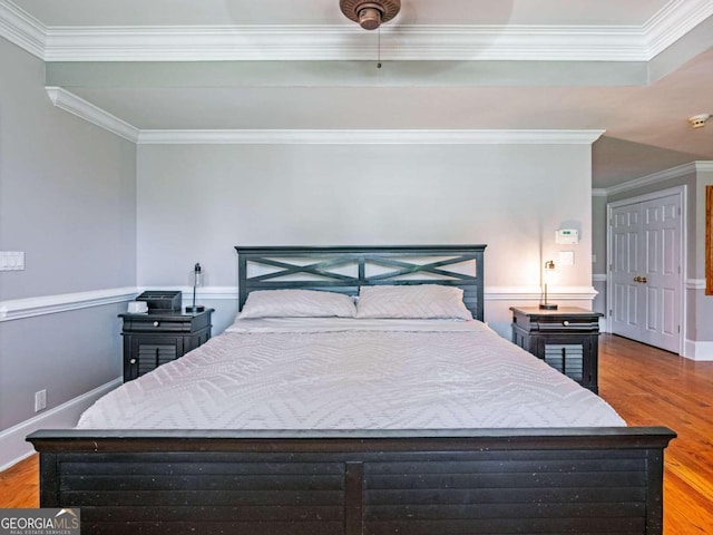 bedroom with light hardwood / wood-style flooring and ornamental molding