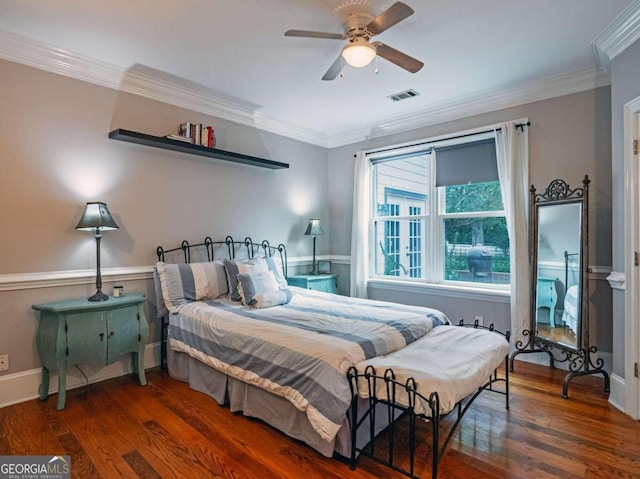 bedroom with ceiling fan, ornamental molding, and dark wood-type flooring