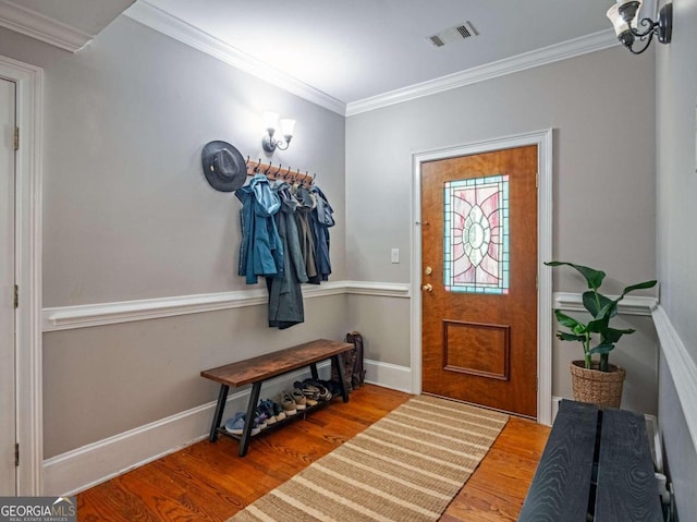 entrance foyer featuring wood-type flooring and ornamental molding