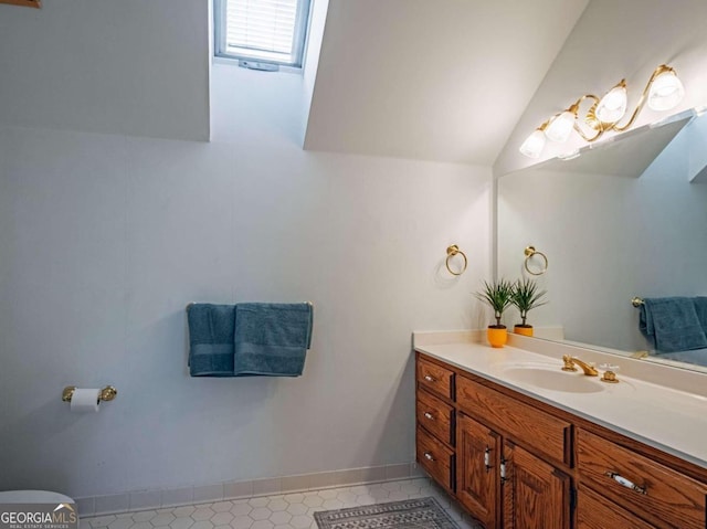 bathroom featuring vanity and vaulted ceiling