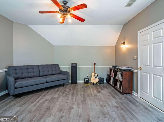 interior space featuring ceiling fan, light wood-type flooring, and vaulted ceiling