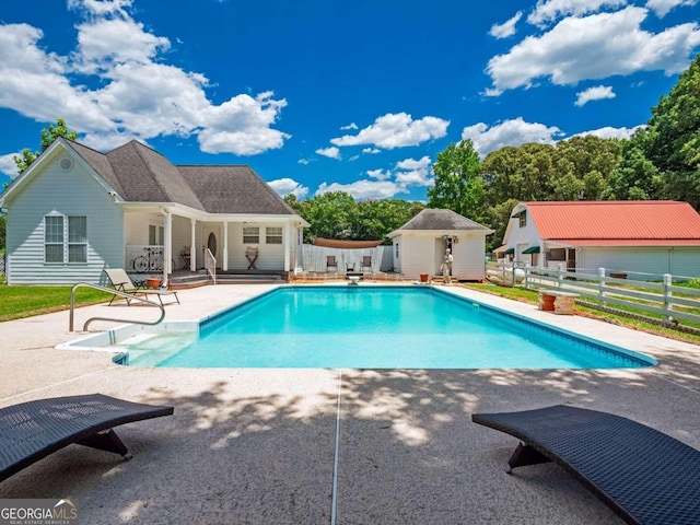 view of swimming pool with a patio area and an outdoor structure