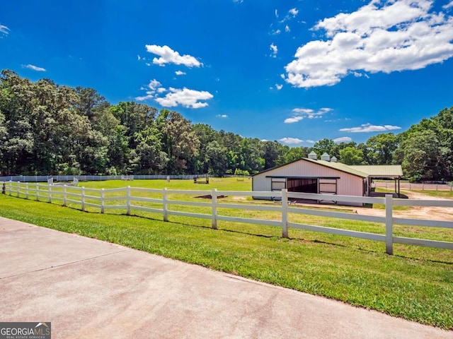 view of yard with a rural view and an outbuilding