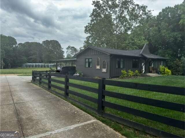 view of side of home featuring a lawn