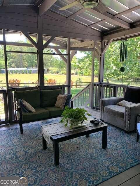 sunroom / solarium featuring vaulted ceiling and a wealth of natural light