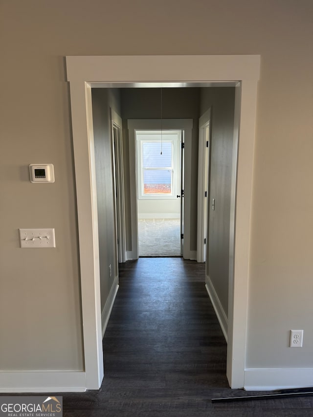 hall with dark hardwood / wood-style floors