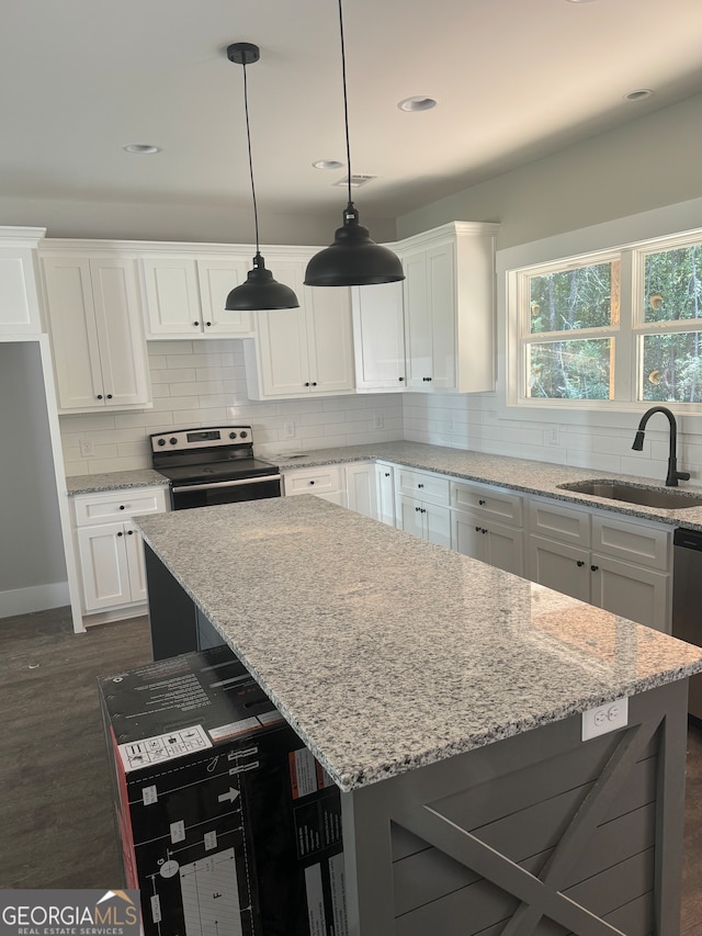 kitchen featuring white cabinets, light stone countertops, dark hardwood / wood-style flooring, and electric range