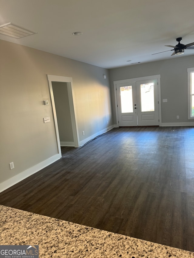 interior space with dark hardwood / wood-style flooring, french doors, and ceiling fan