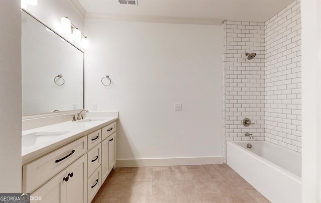 bathroom featuring tile patterned floors, vanity, and tiled shower / bath