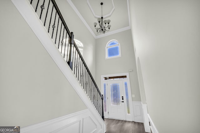 1216 Trophy Club Ave, Dacula, GA 30019 - entrance foyer featuring ornamental molding, a towering ceiling, a chandelier, and dark wood-type flooring