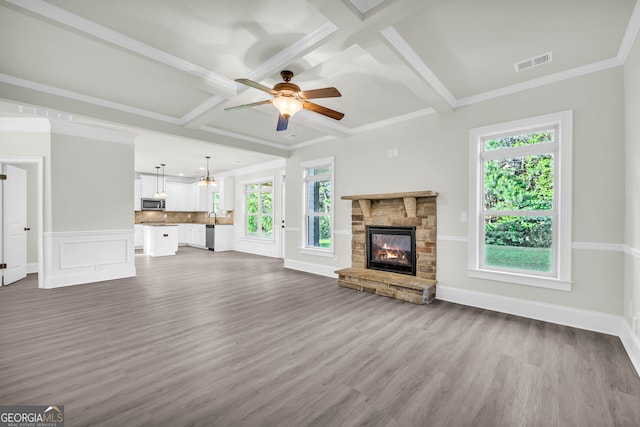 1216 Trophy Club Ave, Dacula, GA 30019 - unfurnished living room featuring a stone fireplace, coffered ceiling, ceiling fan, and hardwood / wood-style floors