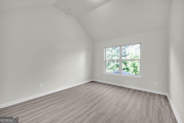 1216 Trophy Club Ave, Dacula, GA 30019 - empty room featuring light hardwood / wood-style floors and vaulted ceiling
