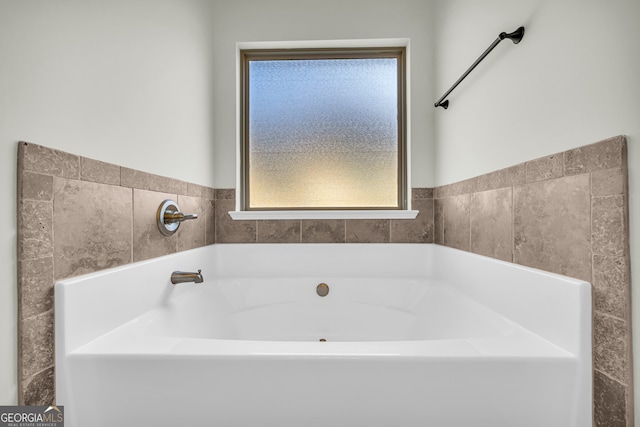 1216 Trophy Club Ave, Dacula, GA 30019 - bathroom featuring a bath and a wealth of natural light