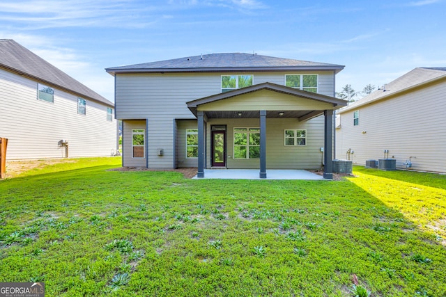 1216 Trophy Club Ave, Dacula, GA 30019 - rear view of property with a patio, a lawn, and central AC