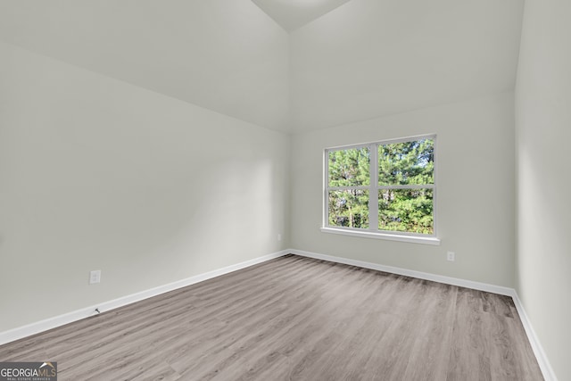 1216 Trophy Club Ave, Dacula, GA 30019 - unfurnished room with light hardwood / wood-style flooring and lofted ceiling