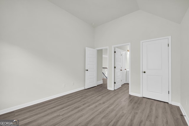 1216 Trophy Club Ave, Dacula, GA 30019 - unfurnished bedroom featuring high vaulted ceiling and hardwood / wood-style flooring