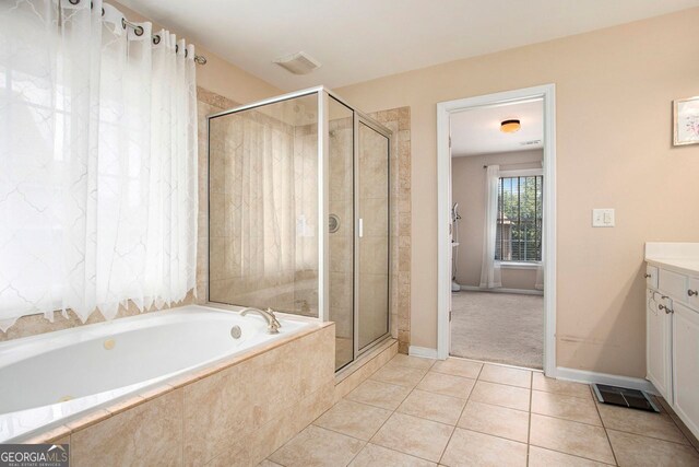 bathroom featuring tile patterned flooring, vanity, and independent shower and bath