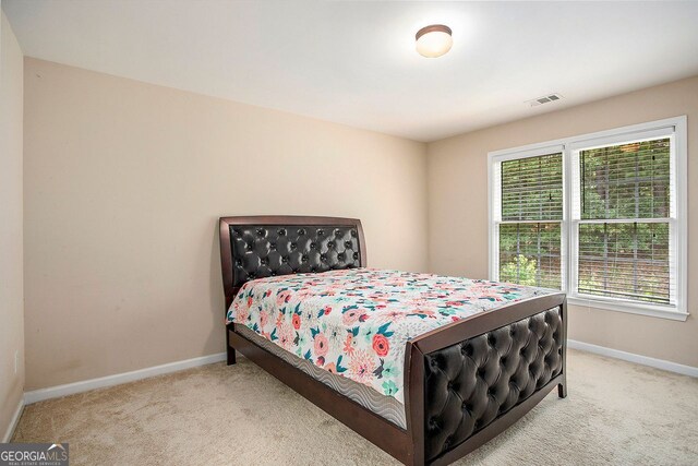 carpeted bedroom featuring multiple windows