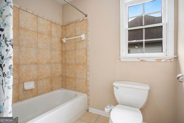 bathroom featuring toilet, shower / bath combo, and tile patterned floors