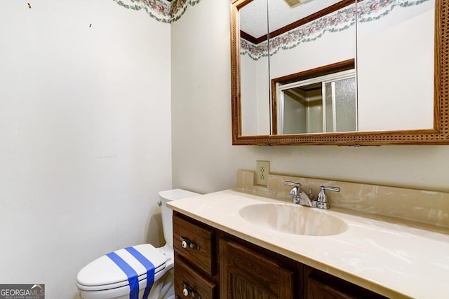 bathroom featuring vanity and toilet