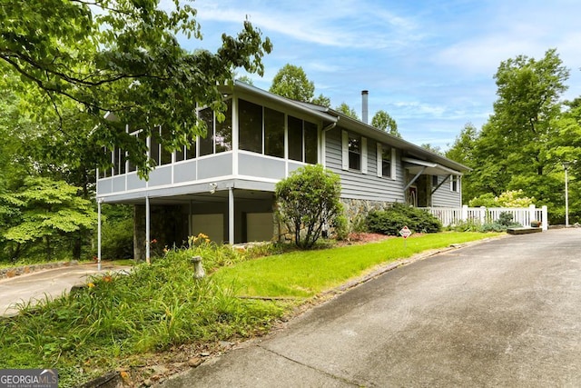 view of front of home featuring a sunroom