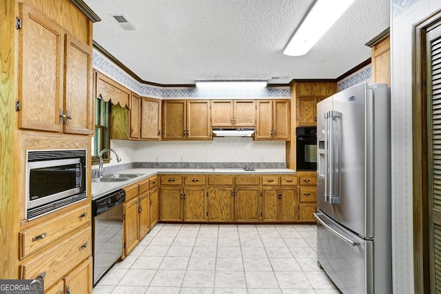 kitchen with sink, light tile patterned floors, black appliances, and a textured ceiling