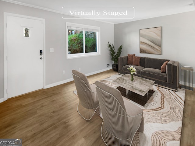 living room featuring wood-type flooring and crown molding