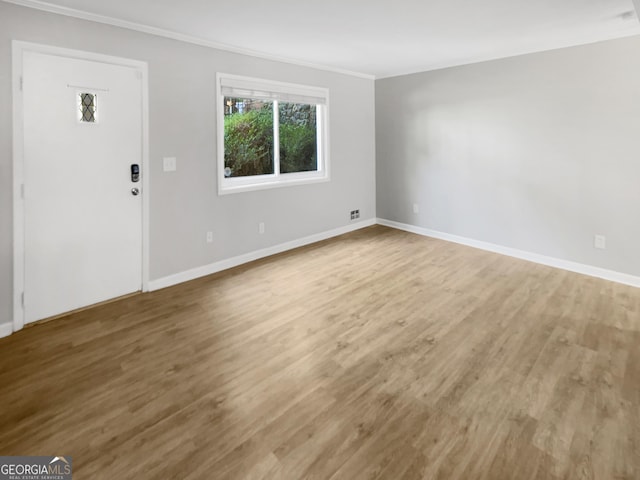 foyer entrance featuring hardwood / wood-style flooring and ornamental molding