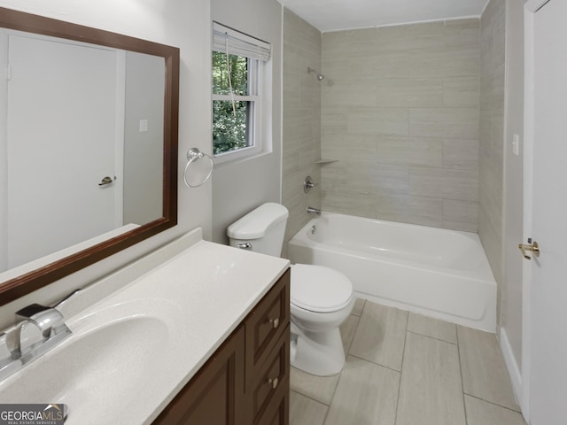 full bathroom featuring tiled shower / bath combo, toilet, and vanity