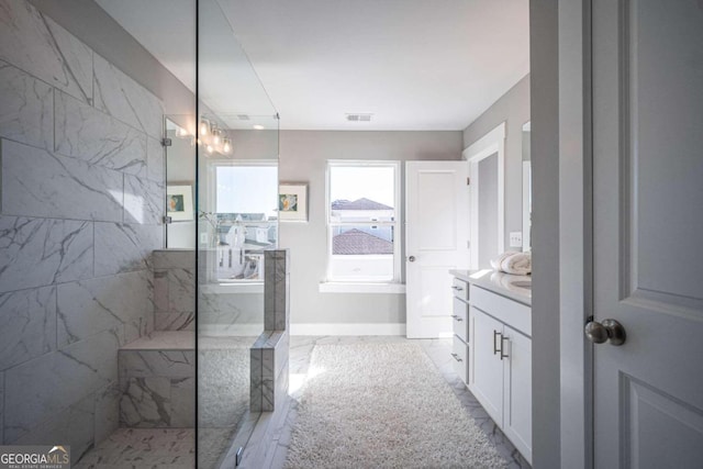 bathroom featuring vanity and tiled shower