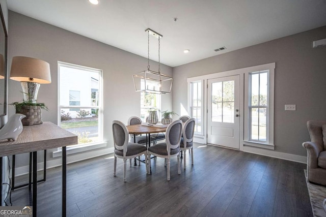 dining area featuring a healthy amount of sunlight and dark hardwood / wood-style flooring